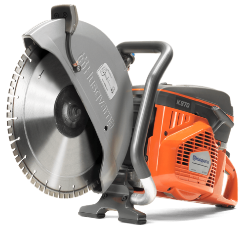 Przecinarka spalinowa K 970 14 Husqvarna w kolorze pomarańczowym i szarym. Ujęcie z boku, stojąca, z widocznym metalowym ostrzem. Zawiera logo Husqvarna oraz czytelną etykietę techniczną. Idealna do cięcia betonu i innych twardych materiałów.