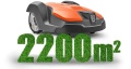 Robot koszący Husqvarna Automower® 520 w kolorze pomarańczowym z szaro-czarnym wykończeniem. Ujęcie boczne, stojący na jednolitym tle. Z przodu widać logo Husqvarna oraz napis 2200 m² w formie zielonego trawnika, wskazującego zakres koszenia.