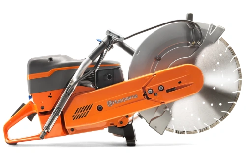 Przecinarka spalinowa Husqvarna K 1270 w pomarańczowo-szarej obudowie z dużą metalową tarczą, uchwytem do prowadzenia i widocznym logo. Produkt pokazany z boku, na plecach, ukazując detale konstrukcji i mocowania.
