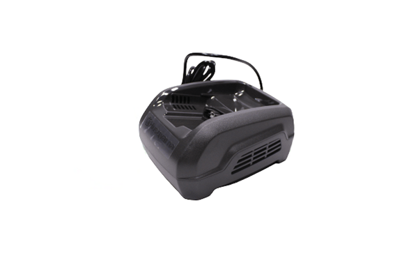 Ładowarka do akumulatorów QC250 w kolorze czarnym, w pozycji leżącej, z widoczną wtyczką i otworami wentylacyjnymi. Kształt prostokątny z zaokrąglonymi krawędziami, z widocznymi napisami na obudowie.
