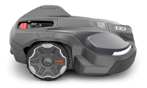 Automower® 450X NERA, ciemnoszary robot koszący z białymi akcentami, leżący z boku. Widoczne koła i panel sterujący z czerwonym przyciskiem. Ergonomiczny design do efektywnego koszenia trawnika.