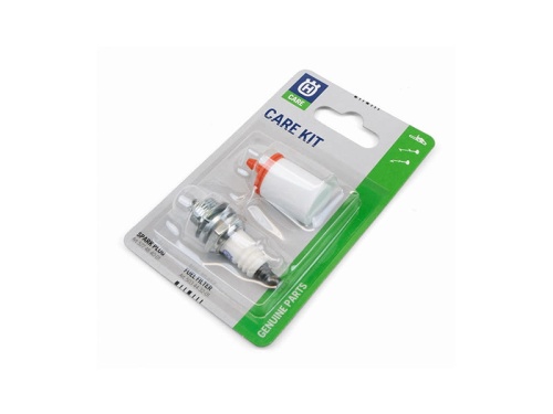 Zestaw serwisowy do pilarki Husqvarna w opakowaniu. Widoczne elementy to świeca zapłonowa z metalową podstawą i białym korpusem oraz filtr paliwa z czerwonym dekielkiem. Opakowanie kartonowe z logo Husqvarna i oznaczeniem Genuine Parts.