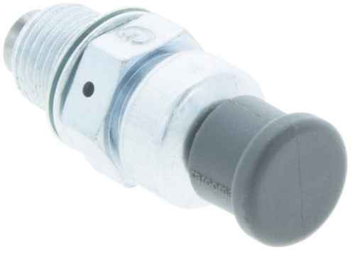 Dekompresator pilarki 246/340/345 w metalowej obudowie z elementem gumowym. Produkt przedstawiony w zbliżeniu, leżący na jednolitym tle. Widoczne gwintowane mocowanie oraz przycisk w czarnym kolorze. Elementy konstrukcyjne wyraźne.