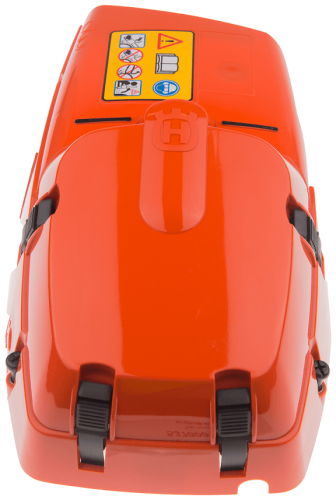 Pomarańczowa plastikowa pokrywa cylindra pilarek Husqvarna 385, 390XP z zapięciami i logo. Widok frontalny na gładką powierzchnię i instrukcje bezpieczeństwa.