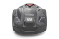 Robot koszący Husqvarna Automower® 310E NERA, widok frontalny. Konstrukcja w odcieniu ciemnoszarym z nieczytelnym logo i napisem. W górnej części znajduje się czerwony przycisk. Produkt ma zaokrąglony kształt z widocznymi uchwytami po bokach.