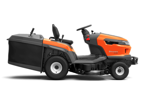 Traktor TC 220T Husqvarna w kolorze pomarańczowym i czarnym, widoczny z boku, z zainstalowanym koszem na trawę. Siedzenie z wysokim oparciem, kierownica z kontrolkami. Opony terenowe, solidna konstrukcja, przystosowany do pracy w ogrodzie.