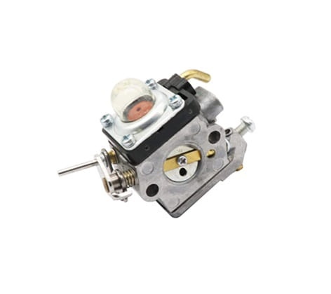 Gaźnik do wykaszarek Husqvarna 129R/325R oraz podkaszarki 129L, w metalowej obudowie. Widoczny element z ciemnym deklem, przezroczystą komorą oraz szczelnym mocowaniem. Produkt pokazany z boku, leżący.