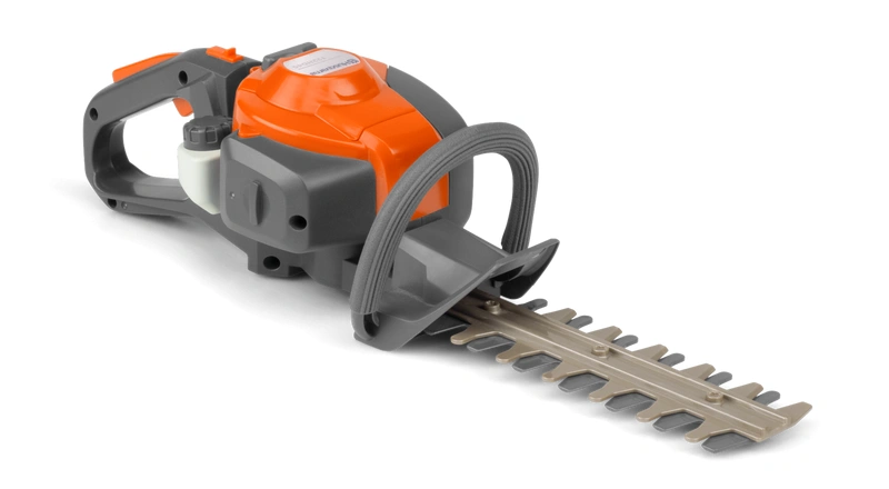 Zabawka dla dzieci Husqvarna, nożyce do żywopłotu w kolorze pomarańczowym i czarnym, z wyraźnymi detalami. Produkt przedstawiony z boku, leżący na jasnym tle.