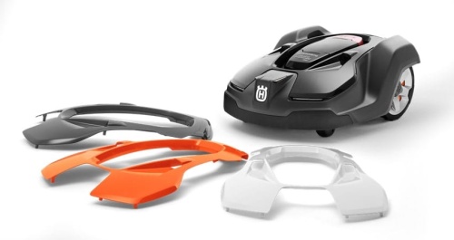 Obudowa robota koszącego Automower 310/315 w trzech kolorach: biała, pomarańczowa i grafitowa. Produkty leżą obok robota, widoczne są gładkie krawędzie i logo. Całość na jednolitym tle, podkreślająca szczegóły i kolorystykę.