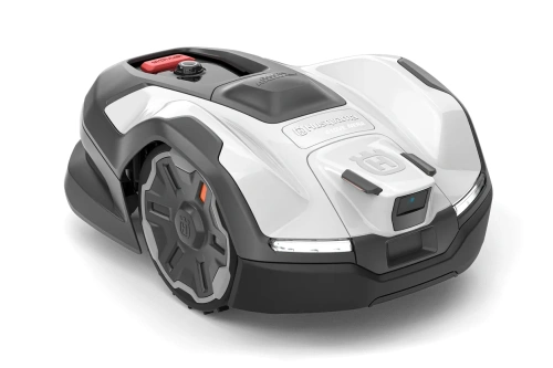 Automower® 410VE NERA to biały robot koszący z charakterystycznym logo Husqvarna, aerodynamicznym kształtem, przyciskiem start i oświetleniem, pokazany z boku na płaskiej powierzchni.
