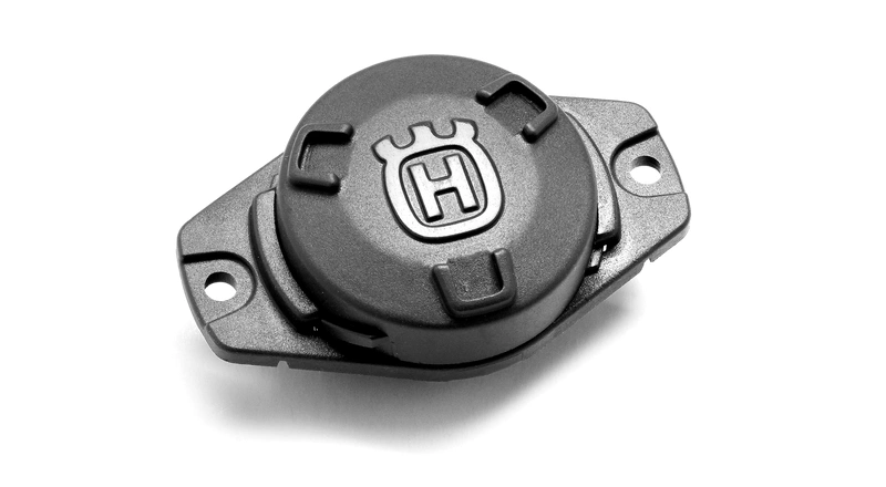 sensor w kolorze szarym, wykonany z tworzywa sztucznego. Widok z góry z widocznym logo Husqvarna.