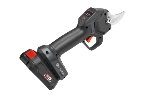 Sekator Aspire PS30X-P4A Husqvarna w kolorze czarnym i szarym, z ergonomicznym uchwytem. Kąt ujęcia: z boku, ukazujący detal ostrza. Widoczne logo Husqvarna na obudowie, akumulator z przodu. Produkt w pozycji stojącej, na jednolitym tle.