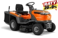 Pomarańczowy traktor Husqvarna TC114 z ciemnoszarymi akcentami, boczny widok. Dwuczęściowe siedzenie, ergonomiczna kierownica, teksturowane koła dla stabilności i widoczny zbiornik na trawę z boku.